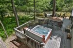 Hot tub on main level with additional seating and river views